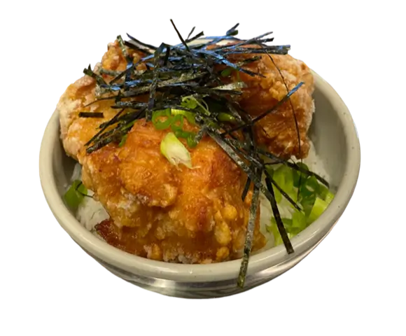 Karaage Rice Bowl features crispy fried chicken pieces served over a bed of steamed rice, garnished with shredded seaweed and green onions at Torakichi Ramen, a Japanese Ramen restaurant in Palm Springs